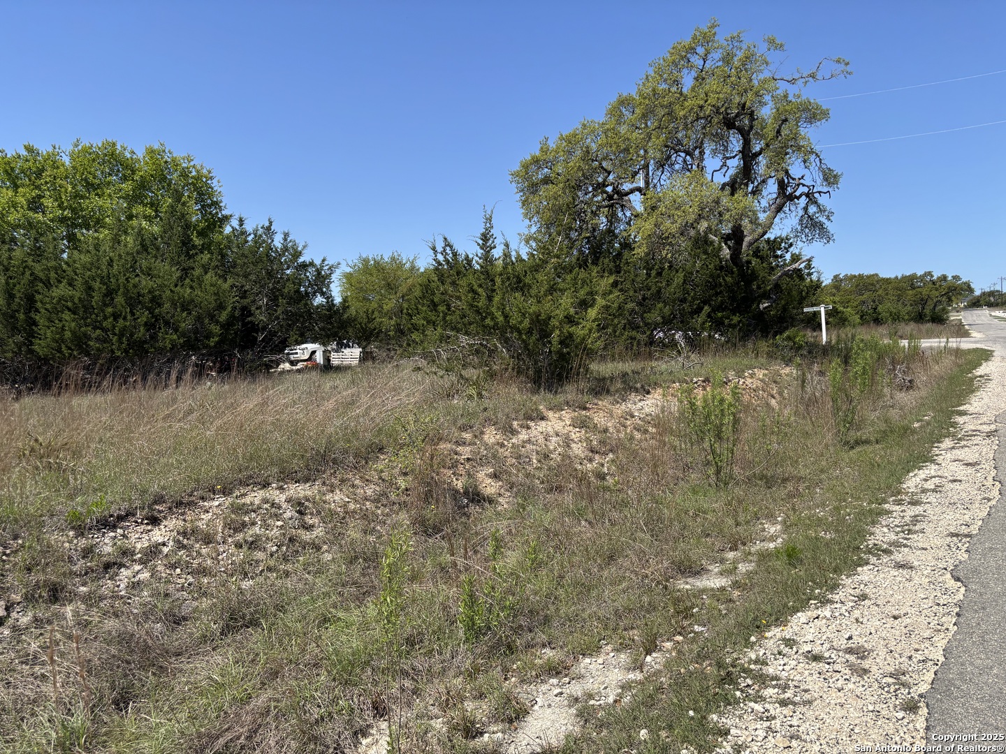Lot 371 West Nicholas Weeks Blanco, TX 78606 - Photo 2 of 18 a view of a lake with houses in the background