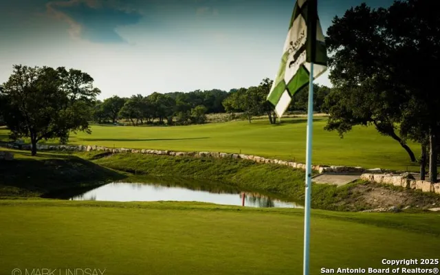 a view of a golf course with a lake view