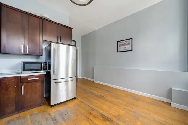 a kitchen with wooden cabinets and stainless steel appliances