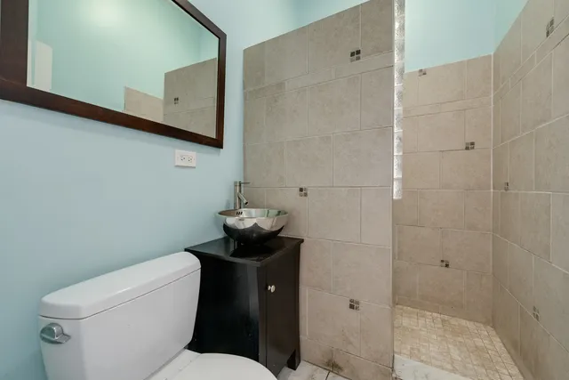 a white toilet sitting next to a bathroom sink