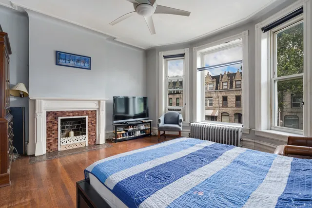 a bedroom with a bed dresser and a flat screen tv