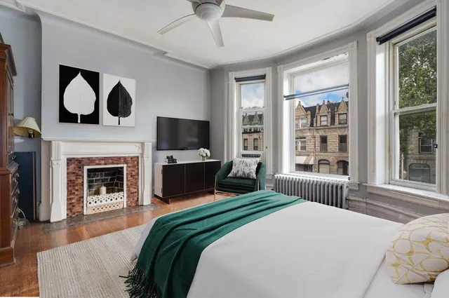 a bedroom with a bed and a fireplace