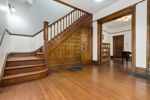 a view of entryway with wooden floor and stairs