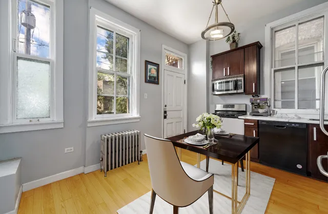 a dining room with furniture a chandelier and wooden floor