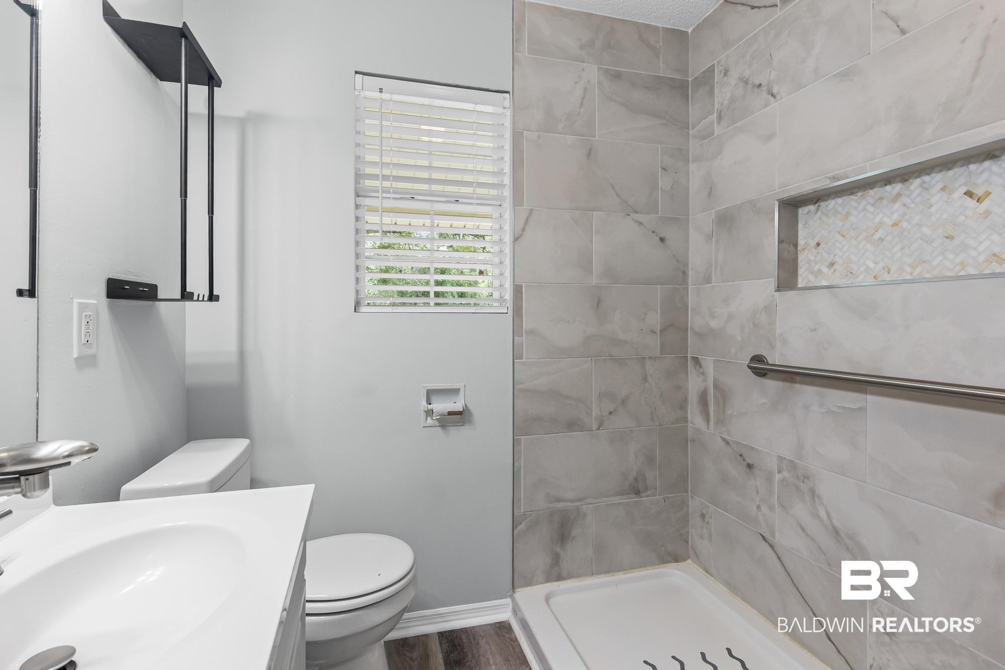 6933 Burbank Court Mobile, AL 36619 - Photo 17 of 25 Contemporary bathroom featuring a walk-in shower with large format tile, a decorative mosaic niche, and a grab bar