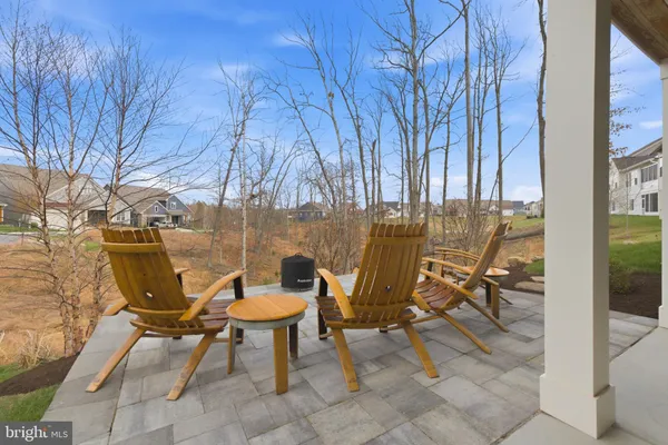 a view of a patio with table and chairs and potted plants