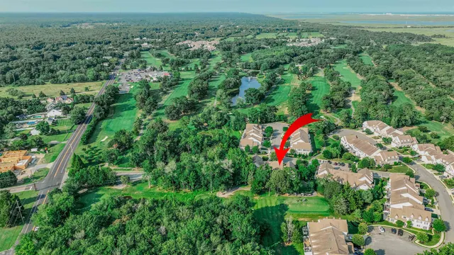 an aerial view of a house with a yard and lake view