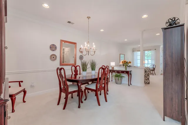 a view of a dining room with furniture and chandelier
