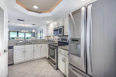 a kitchen with stainless steel appliances granite countertop a refrigerator and microwave