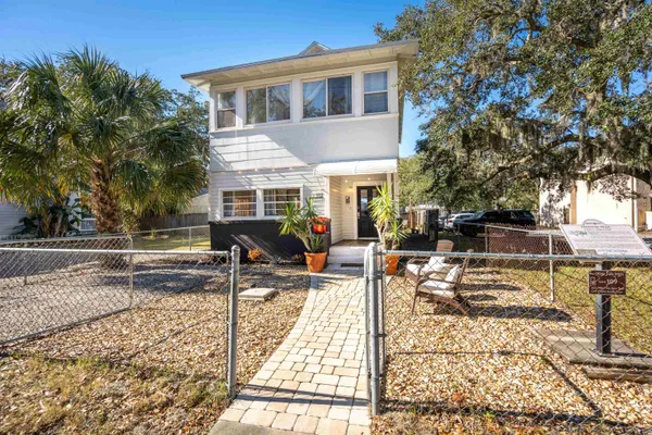 a view of a house with backyard and sitting area