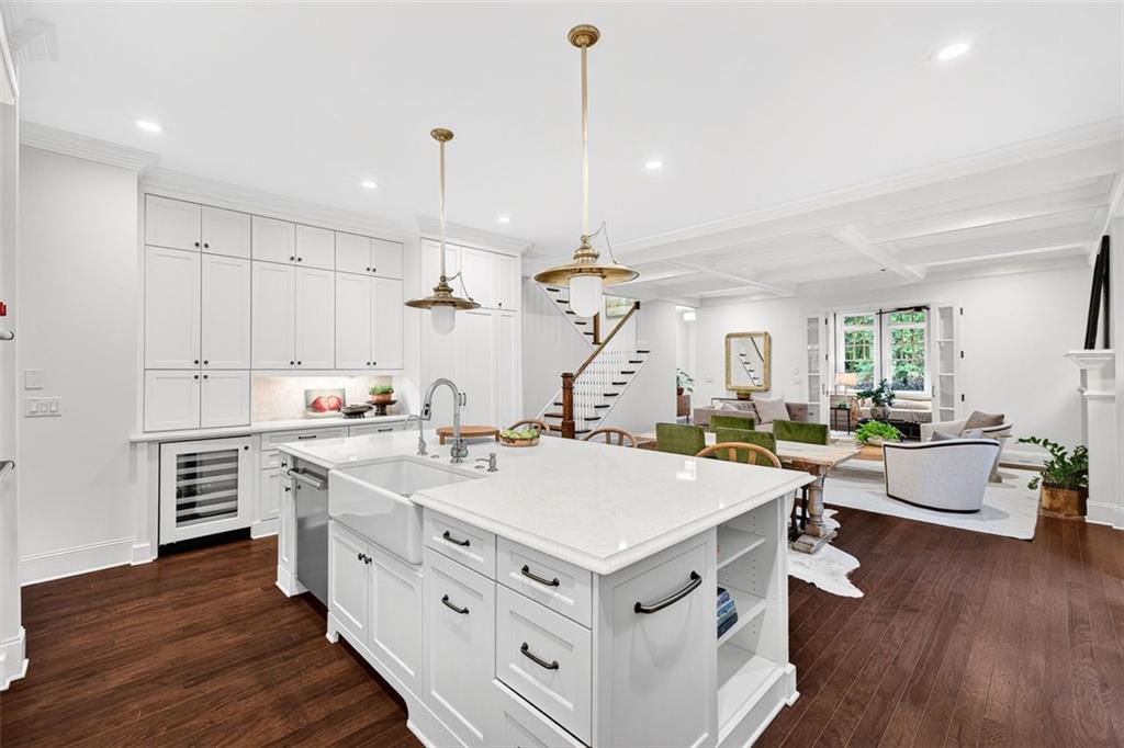 101 Walden Square Way Decatur, GA 30030 - Photo 6 of 33 a view of kitchen island with stainless steel appliances sink stove and wooden floor