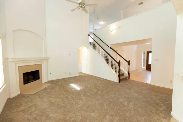 a view of an empty room with wooden floor a fireplace
