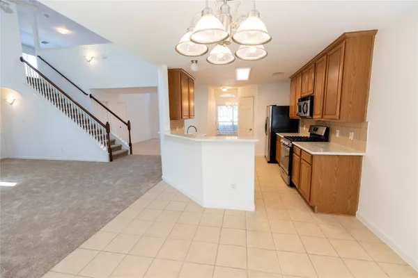 a kitchen with stainless steel appliances a refrigerator a stove a microwave and cabinets