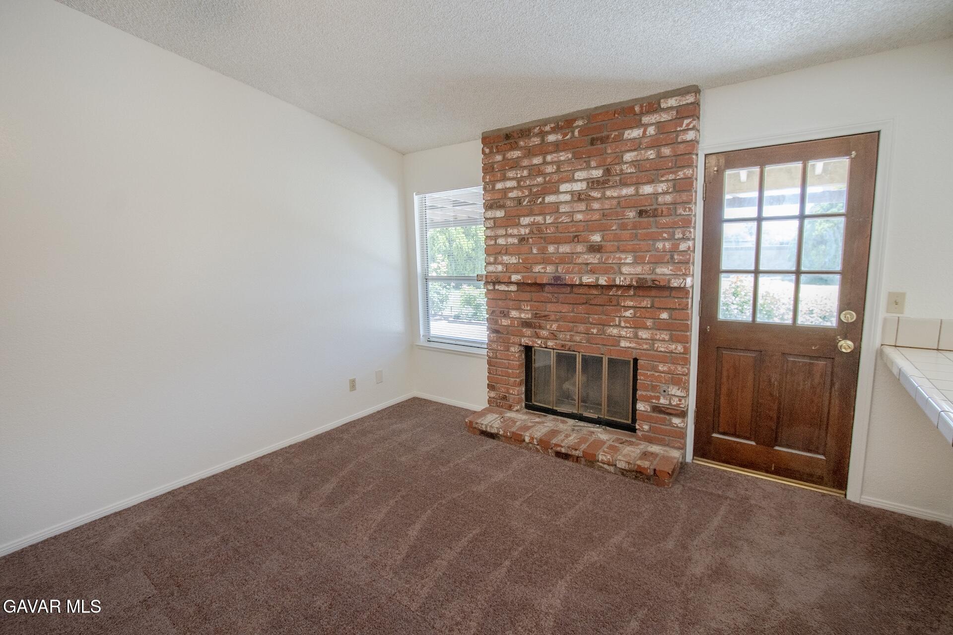 44318 33rd Street West Lancaster, CA 93536 - Photo 18 of 29 an empty room with a fireplace