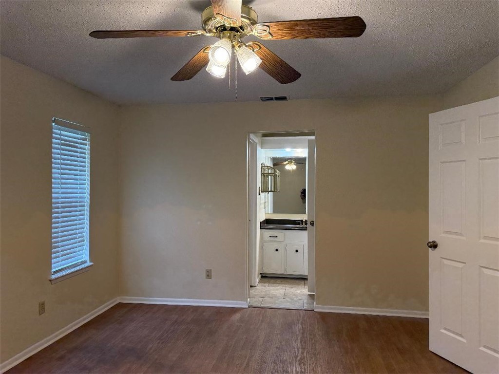 110 Timberview Drive Portland, TX 78374 - Photo 17 of 30 an empty room with wooden floor chandelier fan and windows