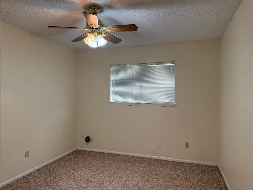 110 Timberview Drive Portland, TX 78374 - Photo 22 of 30 an empty room with a window and a fan
