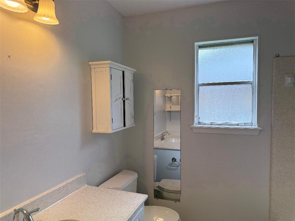 110 Timberview Drive Portland, TX 78374 - Photo 24 of 30 a white toilet sitting next to a bathroom sink