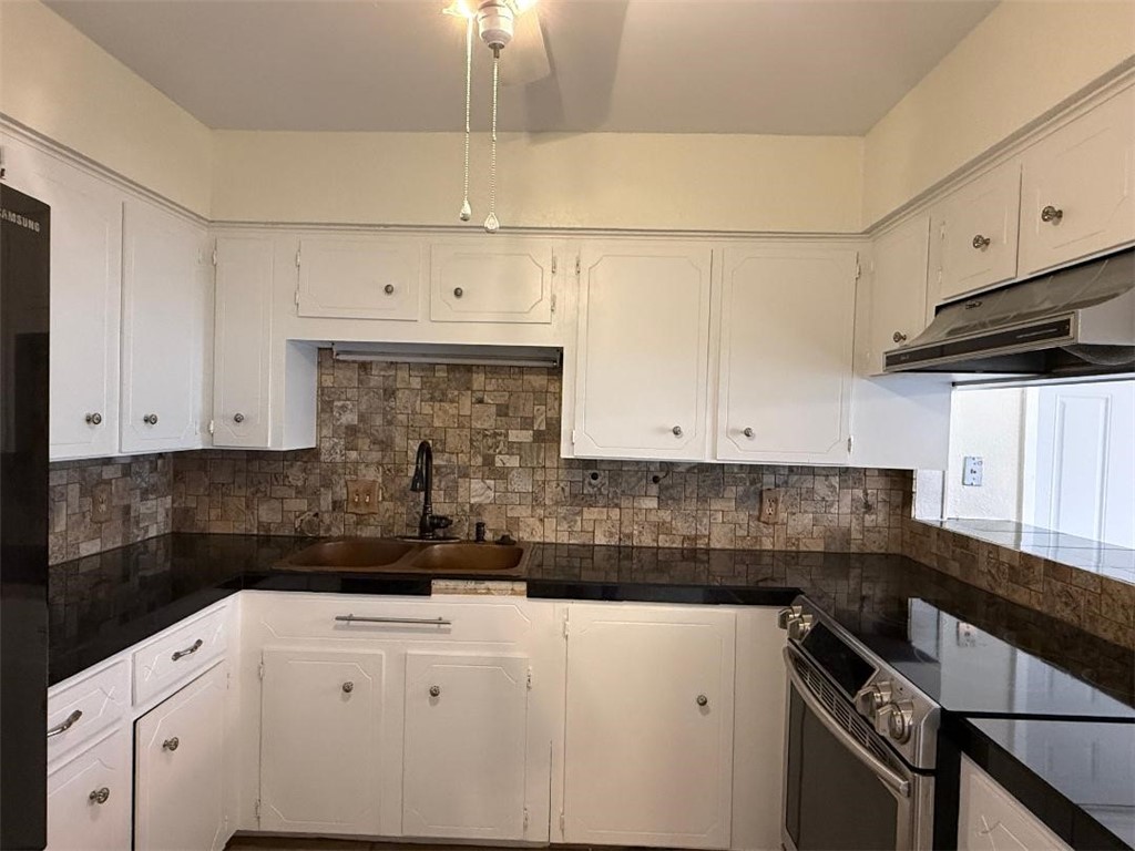 110 Timberview Drive Portland, TX 78374 - Photo 3 of 30 a kitchen with granite countertop a sink a stove and cabinets