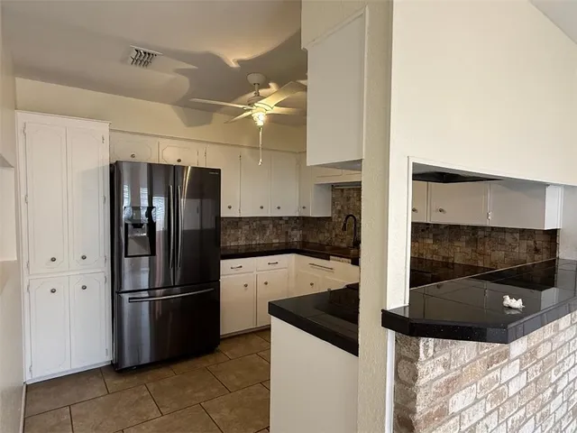 a kitchen with a refrigerator and a sink
