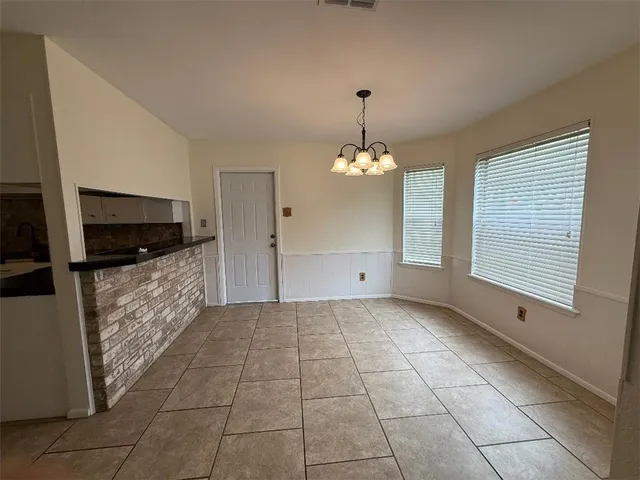 a view of a kitchen with an empty room and kitchen space