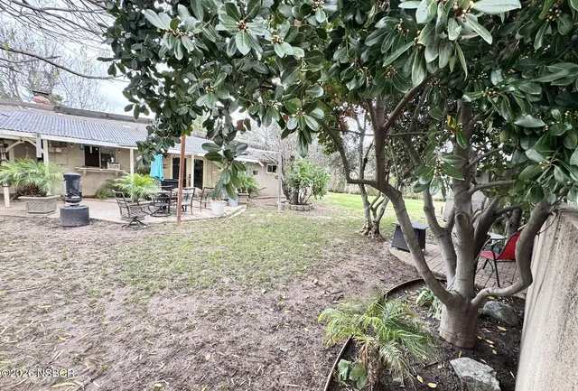 a view of outdoor space with garden and trees