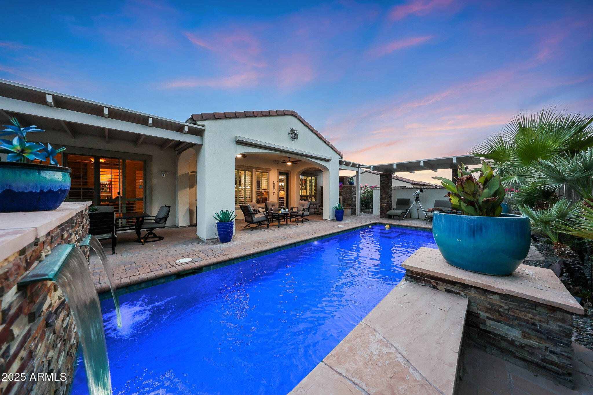 a living room with furniture a flat screen tv and a potted plant