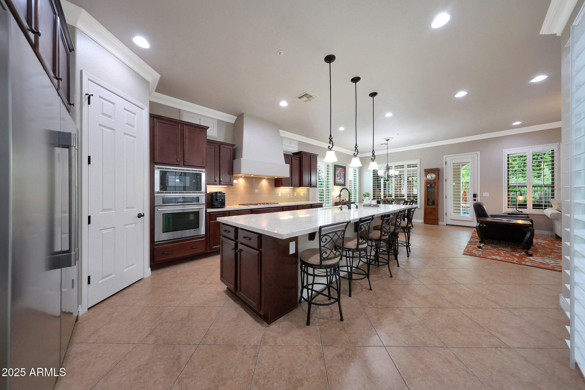 12920 West Roy Rogers Road Peoria, AZ 85383 - Photo 15 of 85 a kitchen with stainless steel appliances kitchen island granite countertop a table and chairs