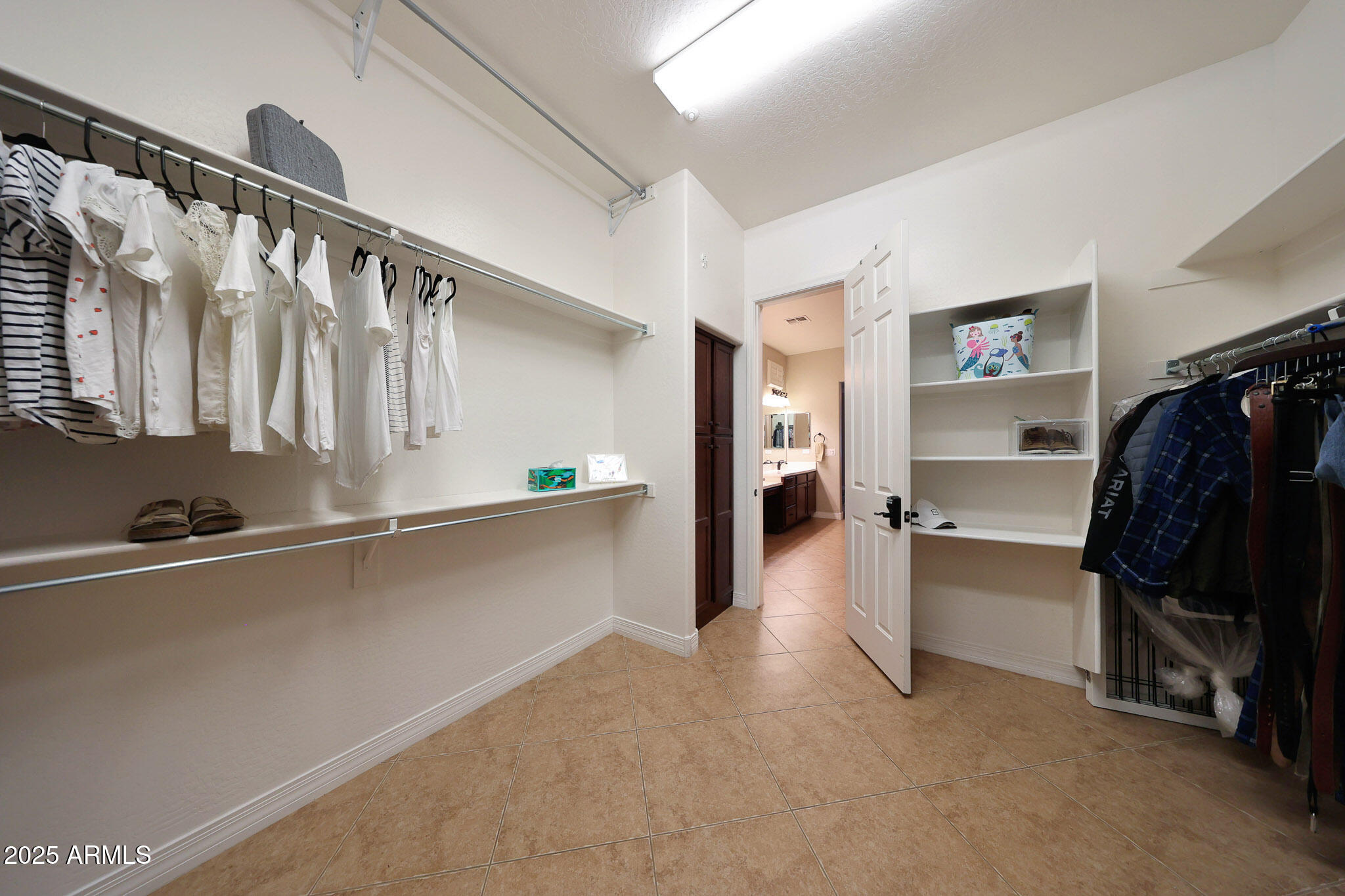 12920 West Roy Rogers Road Peoria, AZ 85383 - Photo 38 of 85 a view of walk in closet with clothes and shoes