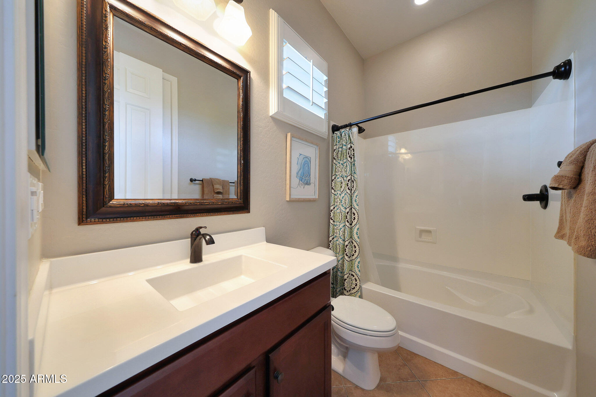 12920 West Roy Rogers Road Peoria, AZ 85383 - Photo 42 of 85 a bathroom with a sink a toilet a mirror and shower