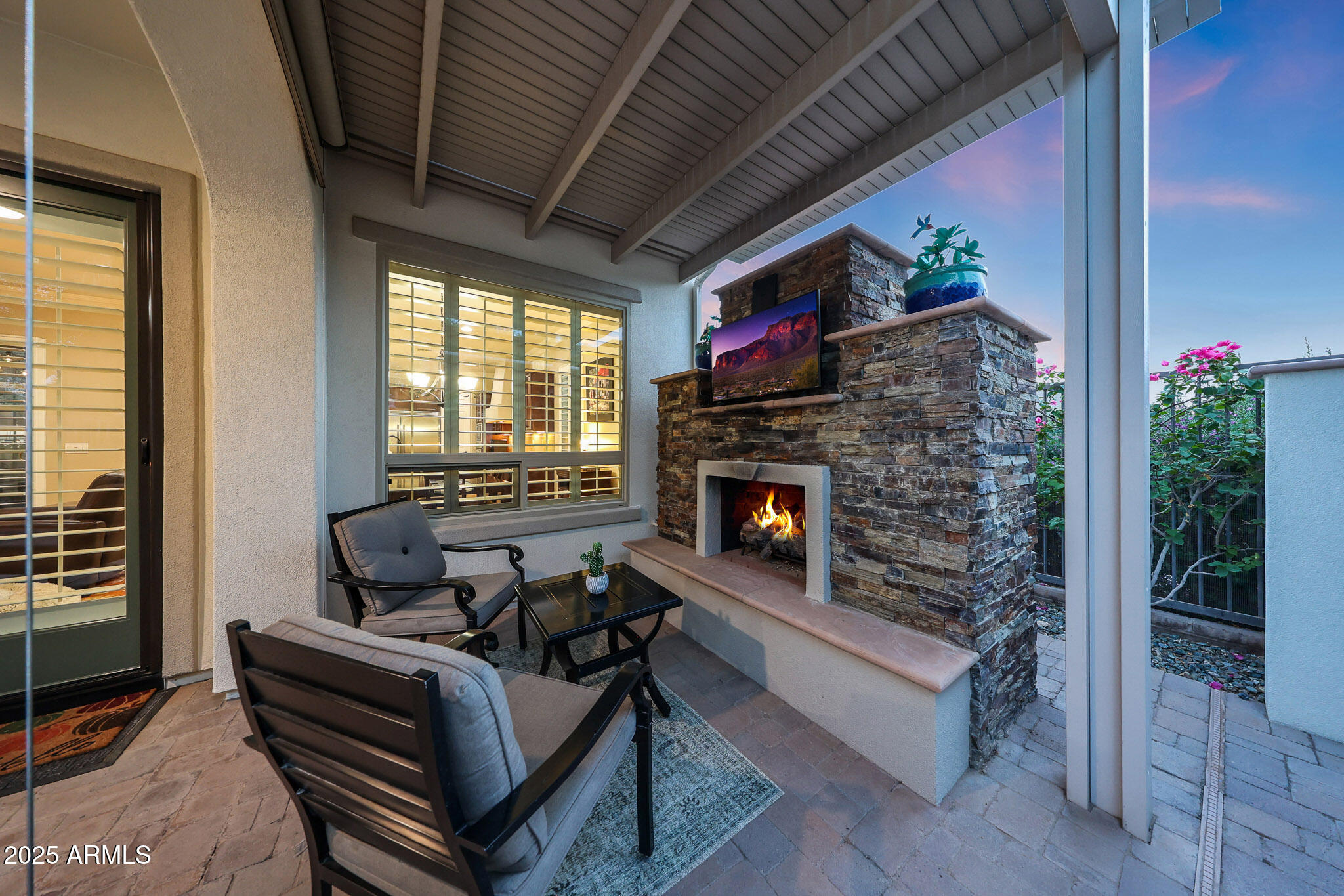 12920 West Roy Rogers Road Peoria, AZ 85383 - Photo 56 of 85 a living room with furniture a flat screen tv and a fireplace