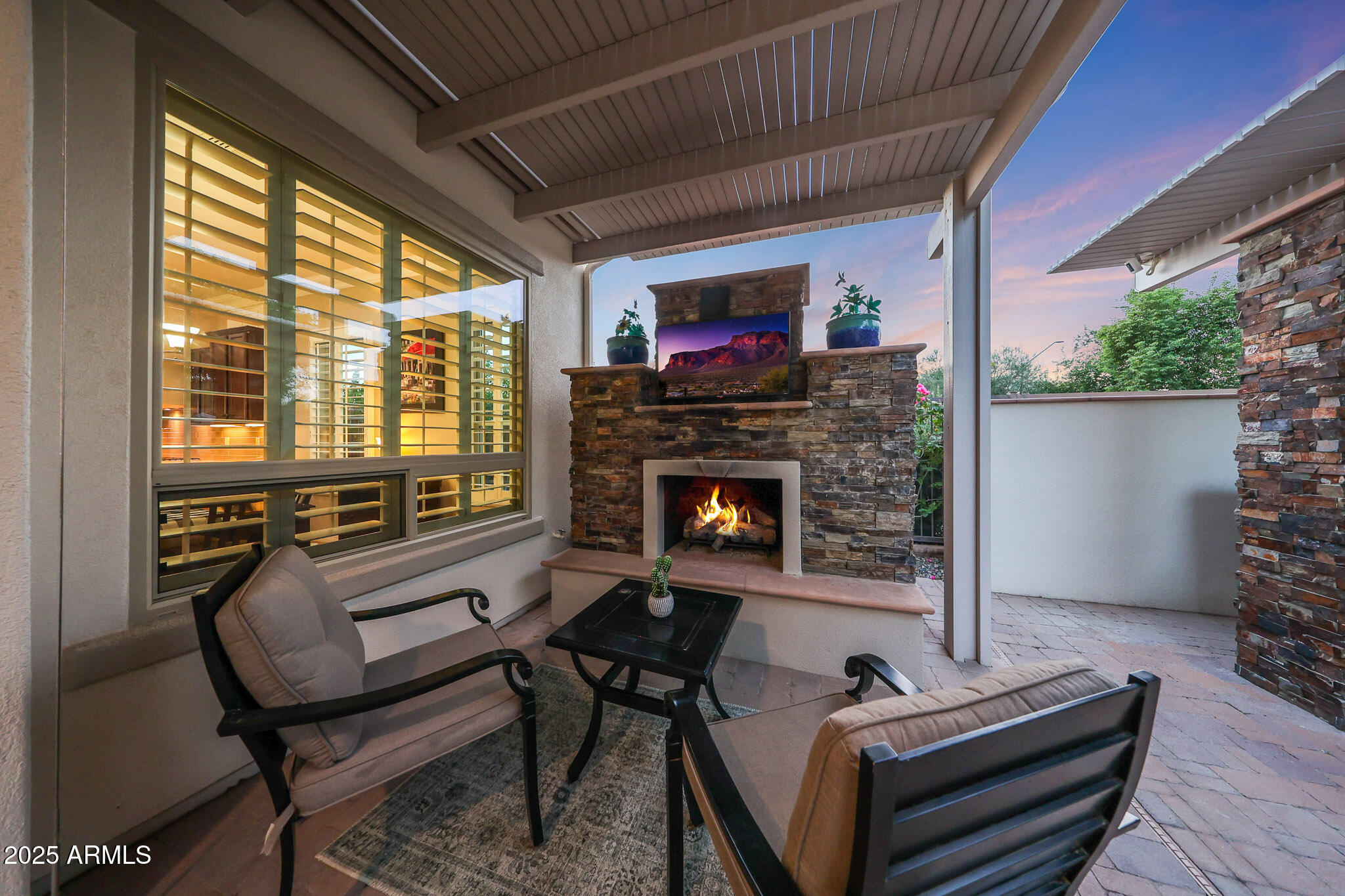 12920 West Roy Rogers Road Peoria, AZ 85383 - Photo 59 of 85 a living room with furniture a flat screen tv and a fireplace