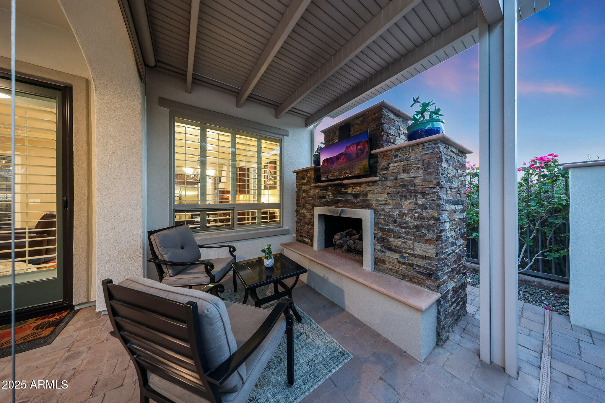 12920 West Roy Rogers Road Peoria, AZ 85383 - Photo 68 of 85 a living room with furniture a flat screen tv and a fireplace