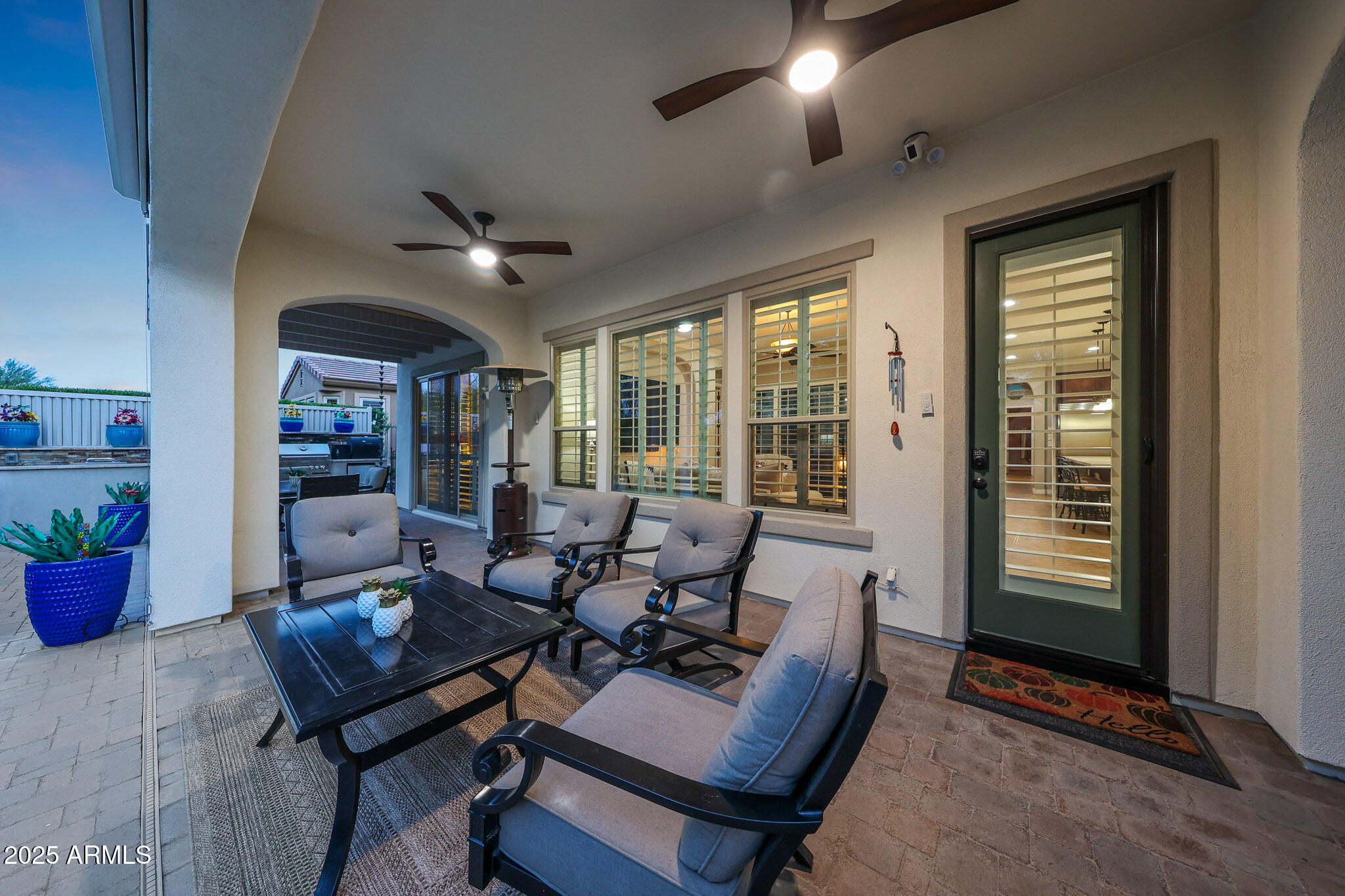 12920 West Roy Rogers Road Peoria, AZ 85383 - Photo 69 of 85 a living room with furniture a chandelier and a potted plant