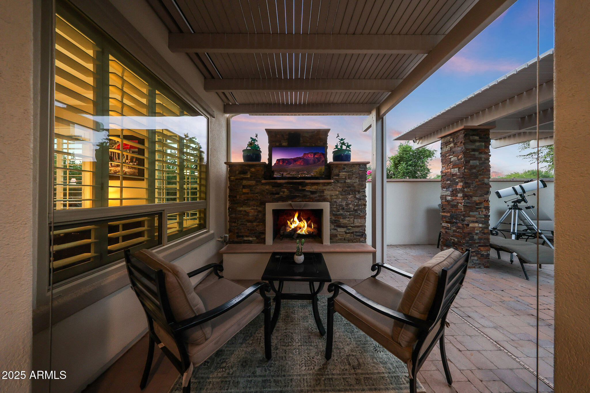 12920 West Roy Rogers Road Peoria, AZ 85383 - Photo 7 of 85 a living room with furniture a flat screen tv and a fireplace