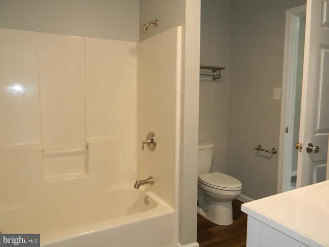 a bathroom with a bathtub and toilet