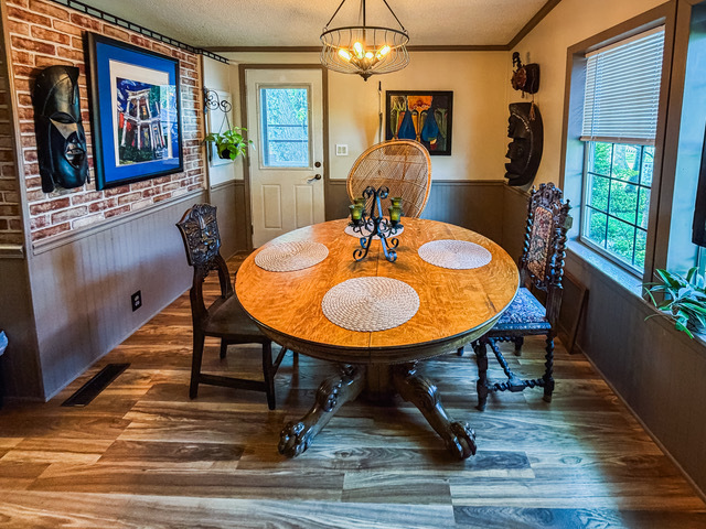 38569 North Sheridan Road, Unit 390 Beach Park, IL 60099 - Photo 5 of 28 a dining room with furniture a chandelier and wooden floor