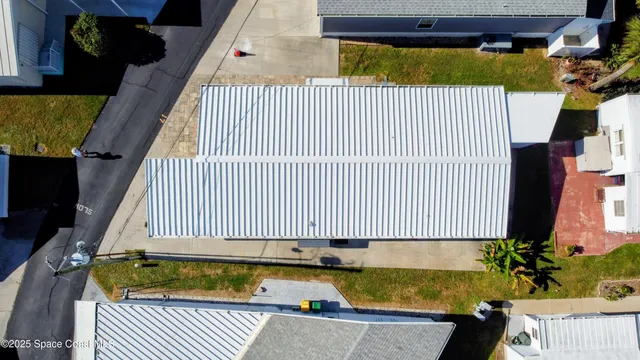 an aerial view of a house with a floor to ceiling window and wooden floor