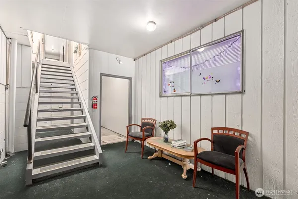 a view of a room with stairs and furniture