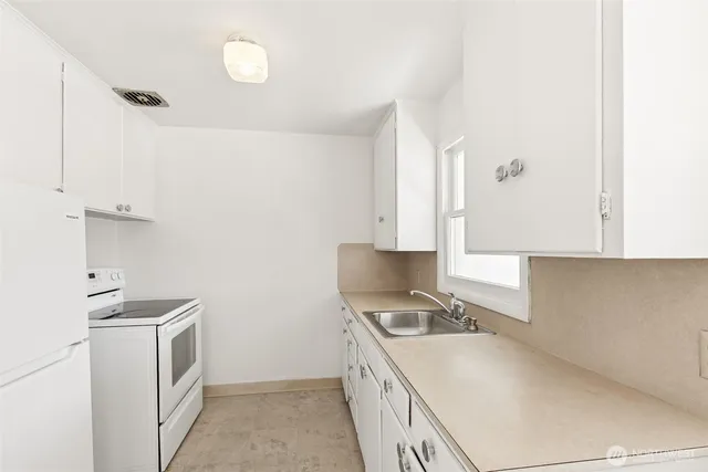 a kitchen with a stove and a sink