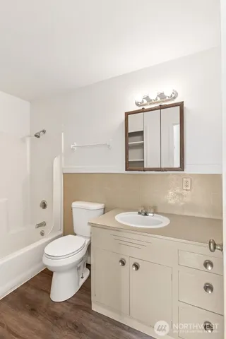 a bathroom with a sink toilet vanity and shower