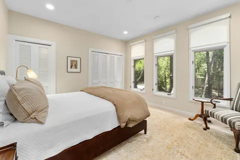 a spacious bedroom with a bed and a large window