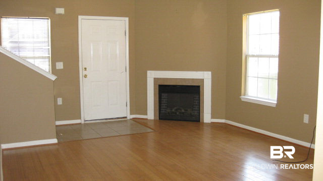 3900 Emerille Drive Foley, AL 36535 - Photo 2 of 6 Spacious living room with an electric fireplace and bamboo flooring.