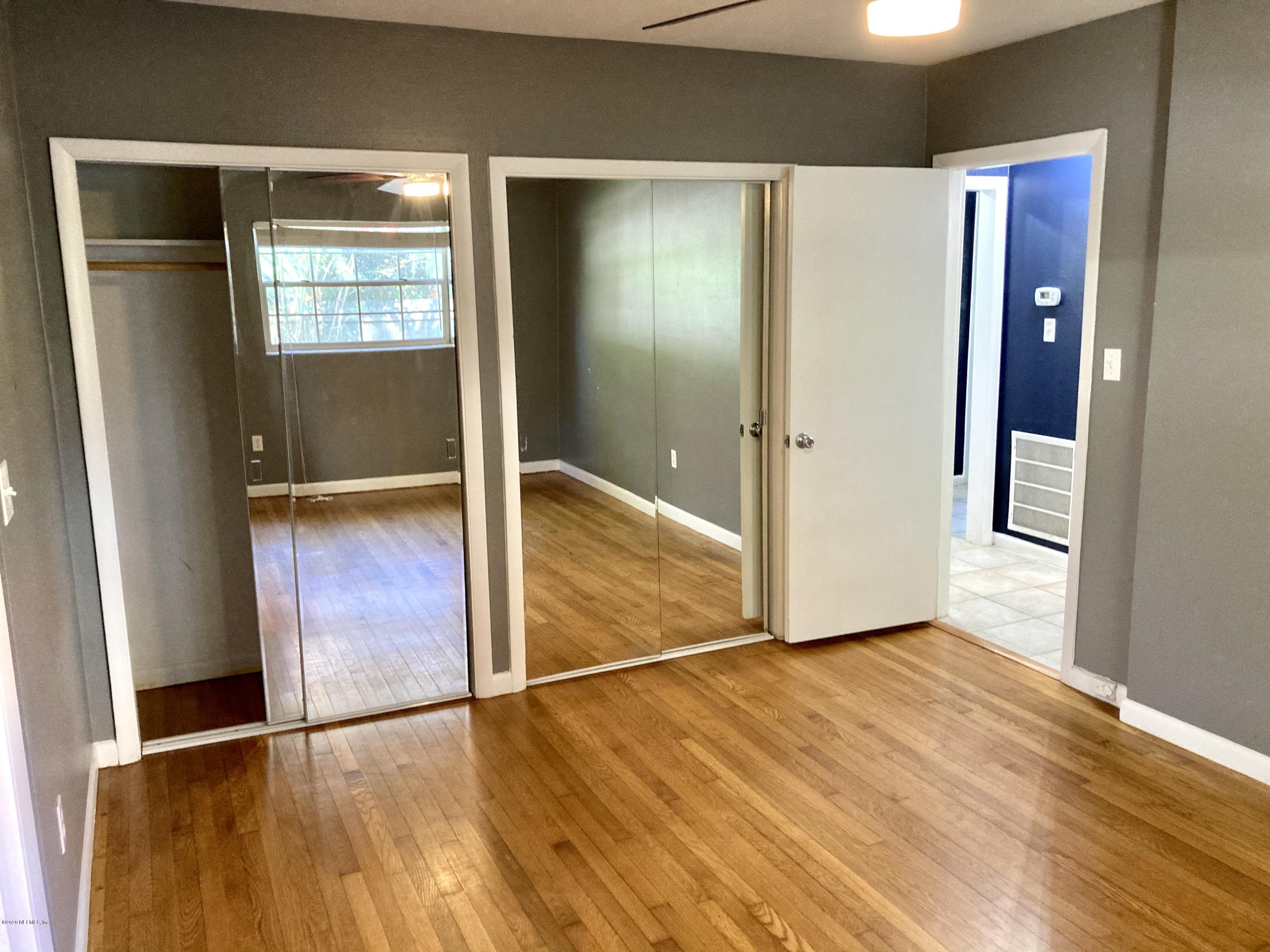 1371 Prince Road St. Augustine, FL 32086 - Photo 4 of 15 an empty room with wooden floor and windows