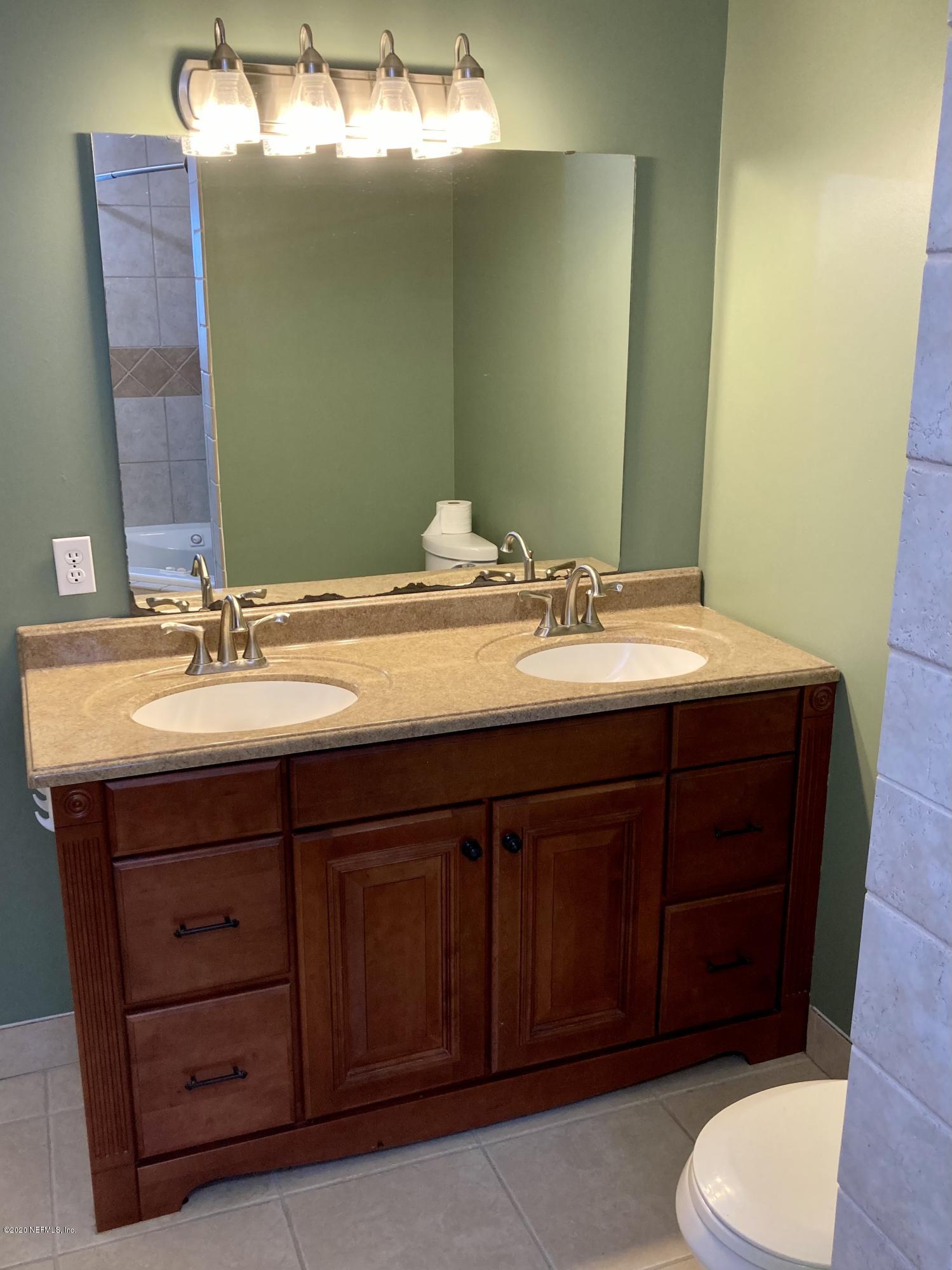 1371 Prince Road St. Augustine, FL 32086 - Photo 5 of 15 a bathroom with a sink vanity mirror and toilet