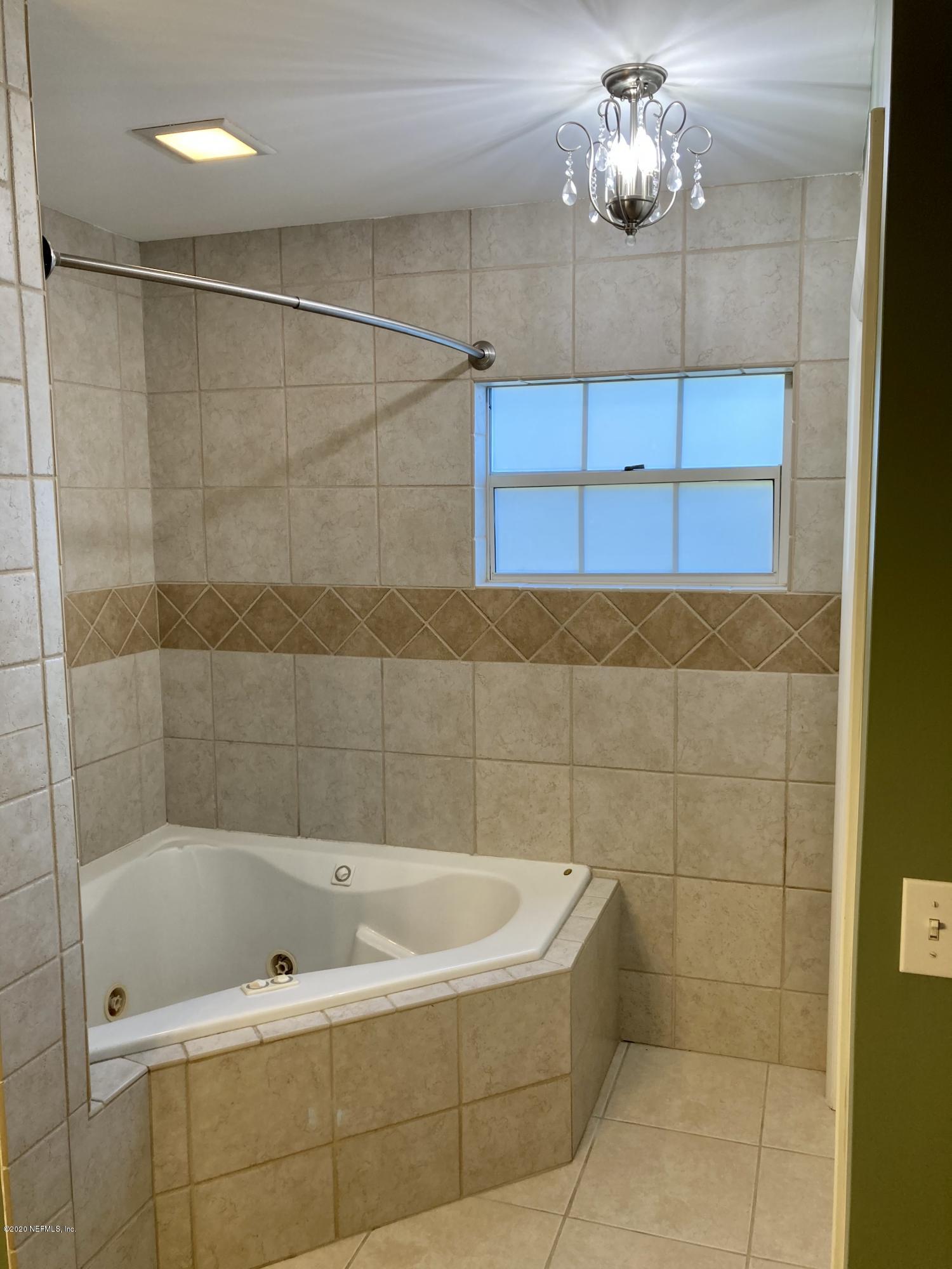 1371 Prince Road St. Augustine, FL 32086 - Photo 6 of 15 a bathroom with a bathtub a shower and a shower