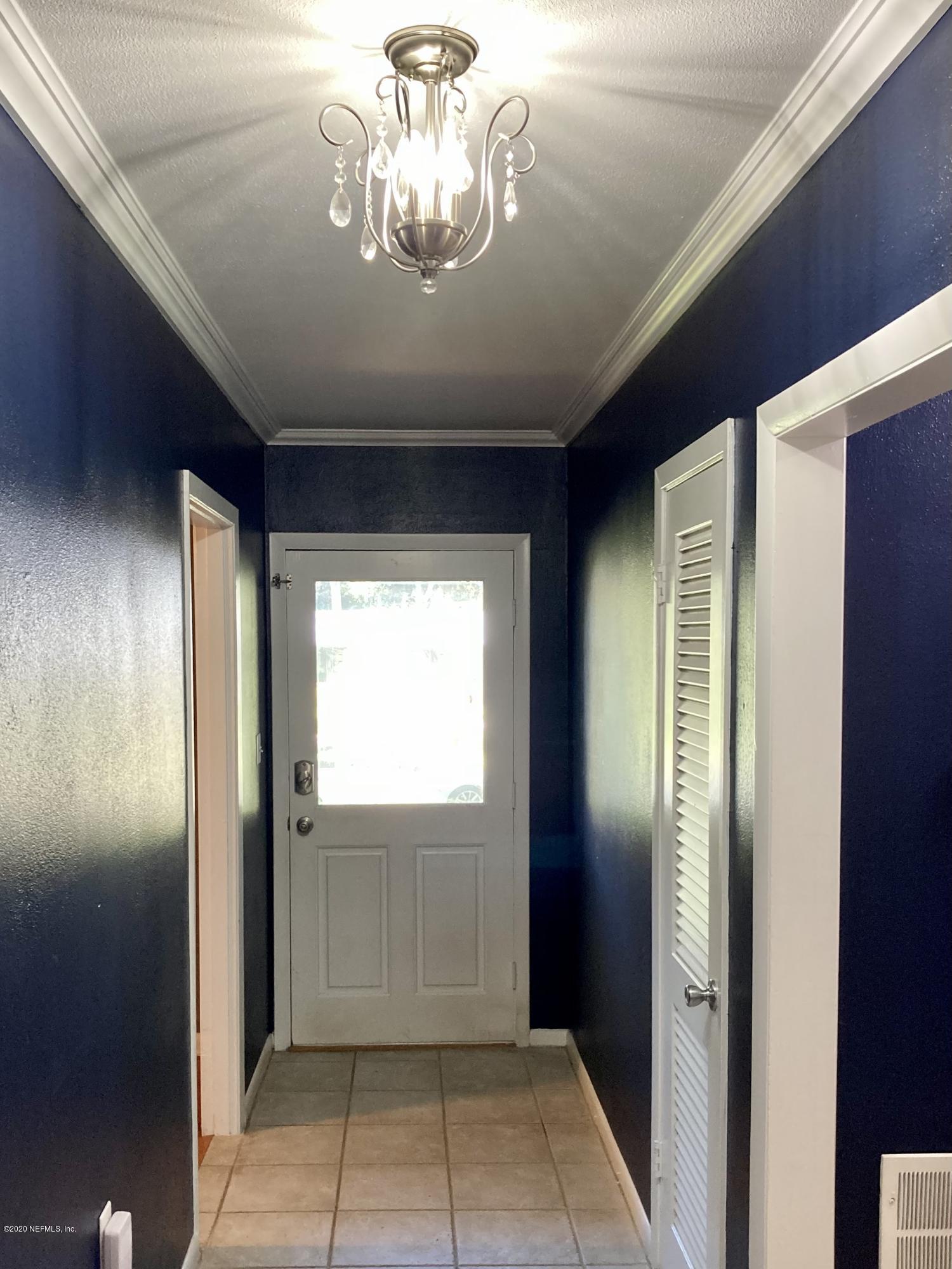 1371 Prince Road St. Augustine, FL 32086 - Photo 8 of 15 a view of a hallway with a chandelier