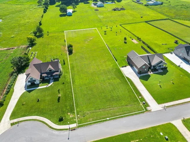 an aerial view of a golf course with a swimming pool
