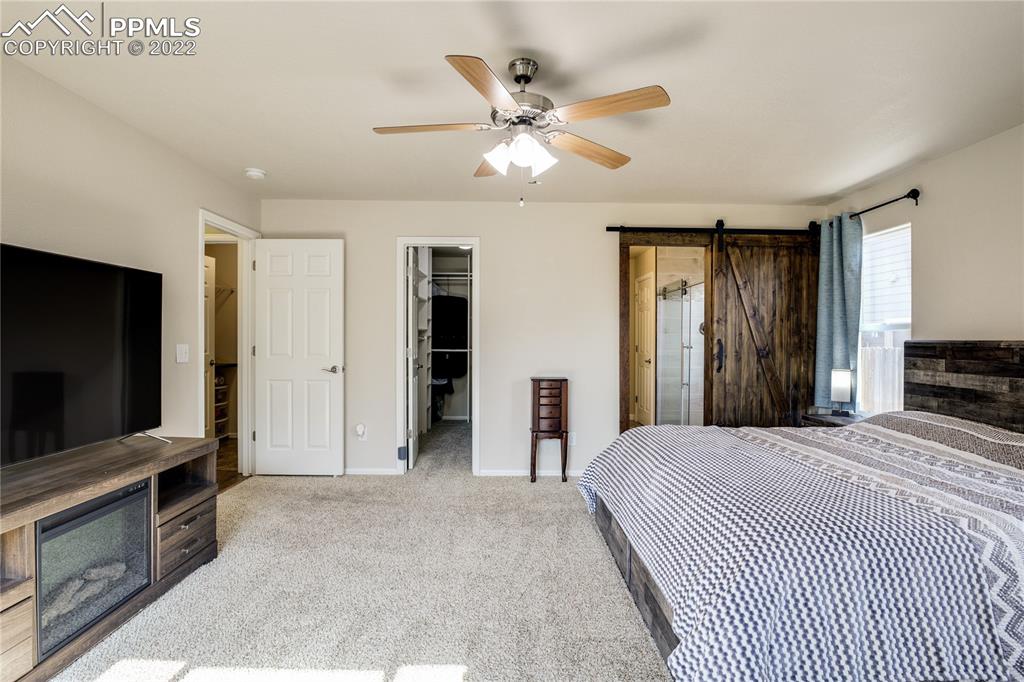 6446 Dancing Moon Way Colorado Springs, CO 80911 - Photo 15 of 42 a bedroom with a bed and a flat screen tv