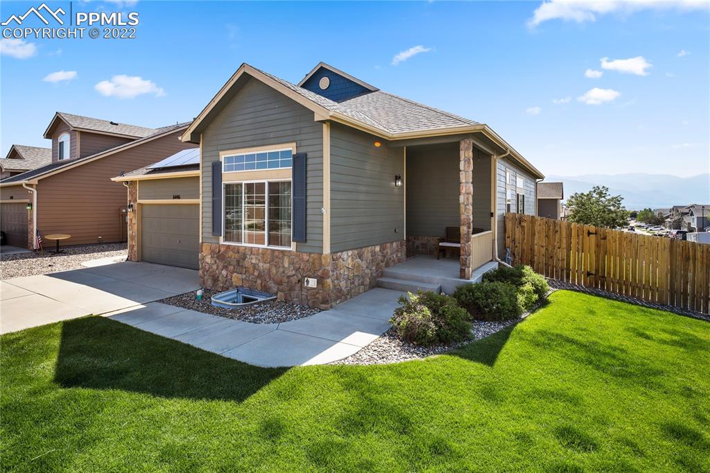 6446 Dancing Moon Way Colorado Springs, CO 80911 - Photo 2 of 42 a front view of house with yard and green space