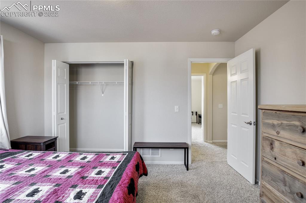 6446 Dancing Moon Way Colorado Springs, CO 80911 - Photo 21 of 42 a bedroom with a bed and a table in it